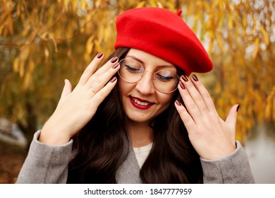 Happy Brunette Woman In Stylish Red Beret, Red Lips And Bordeaux Nails