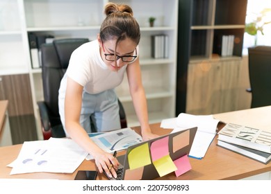 Happy Business Beautiful Asian Woman Work. Glasses Female Worker Busy With Online Group Meeting But Still Smiling And Cheerful. A Professional Confident Employee Having Team Video Call At Workplace.