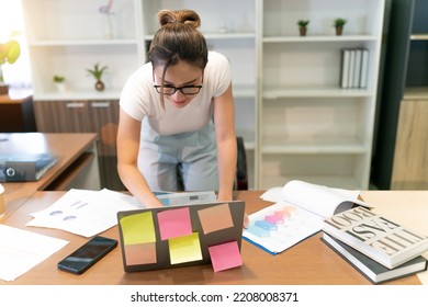 Happy Business Beautiful Asian Woman Work. Glasses Female Worker Busy With Online Group Meeting But Still Smiling And Cheerful. A Professional Confident Employee Having Team Video Call At Workplace.