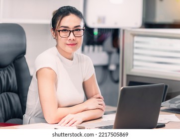 Happy Business Beautiful Asian Woman Work. A Professional Confident Employee Having Team Video Call At Workplace. Glasses Female Worker Busy With Online Group Meeting But Still Smiling And Cheerful.