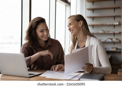 Happy business colleagues analyzing, reviewing project papers, legal documents together. Customer and legal expert meeting at workplace for paperwork. Mentor explaining contract to interns - Shutterstock ID 2161635095
