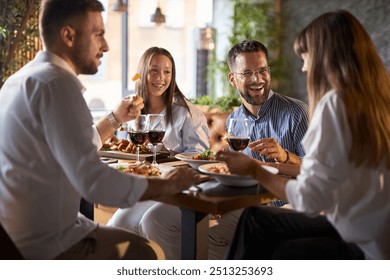 Happy business colleagues having lunch in a restaurant. - Powered by Shutterstock