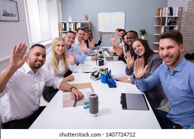 Happy Business Group Of Diverse People Waving Hands During A Meeting Conference In The Office