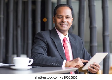 Happy Business Leader Working on Tablet in Cafe