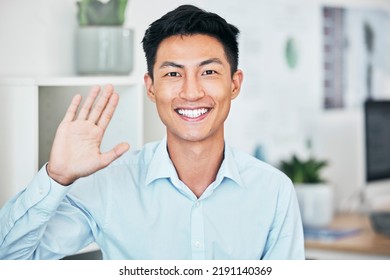 Happy Business Man Greeting, Waving And Saying Hello With Hand Gesture While Smiling And Looking Friendly In An Office. Portrait Of Asian Entrepreneur Saying Thank You Or Welcome During Testimonial