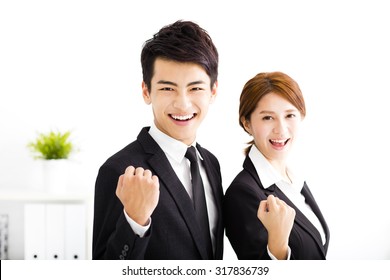 happy business man and woman standing  in office