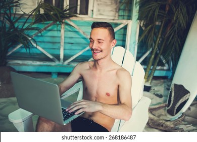 Happy Business Man Working Freelance Using Laptop At The Beach House Of A Tropical Island