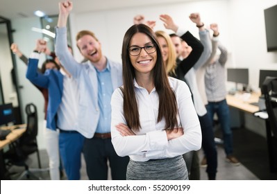 Happy business people celebrating success at company - Shutterstock ID 552090199