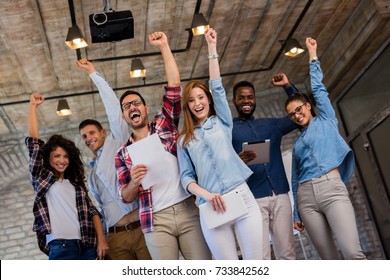 Happy business people celebrating success at company. - Powered by Shutterstock