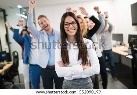 Happy business people celebrating success at company