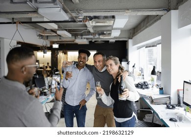 Happy business people with champagne posing for photo in office - Shutterstock ID 2198632129