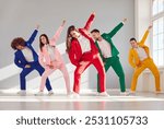 Happy business people dancing together in colorful suits. This vibrant group of dancers showcases the happiness and camaraderie found in team celebration, party and dynamic dance show.