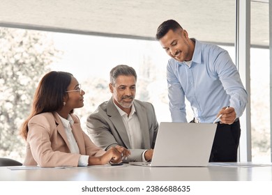 Happy business people executive team working at laptop using computer technology having discussion at office meeting showing financial project results presentation to investor or bank client. - Powered by Shutterstock