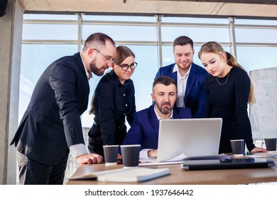 Happy Business People Looking At Laptop Presentation, Success At Work, Sitting In Modern Office. Successful Online Negotiations. Businessmen Share Their Knowledge