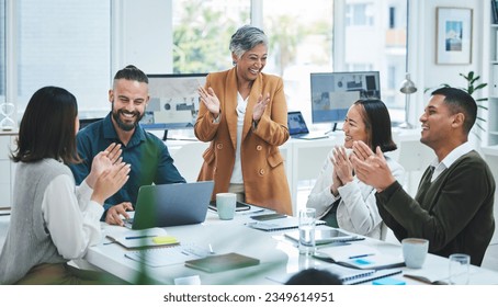 Happy business people in meeting at desk with applause, cheers and celebration of sales target achievement. Clapping, praise and congratulations with success, motivation for men and women in office. - Shutterstock ID 2349614951