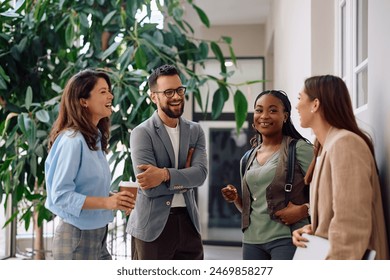 Happy business team communicating on a break in the office. 