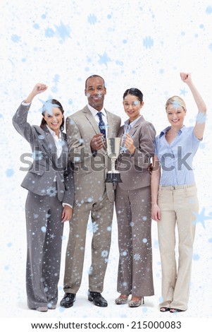 Happy business team holding a cup against snow falling