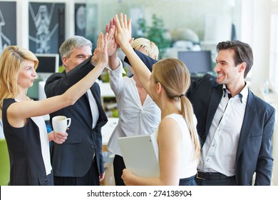 Happy Business Team Making High Five With Their Hands In The Office