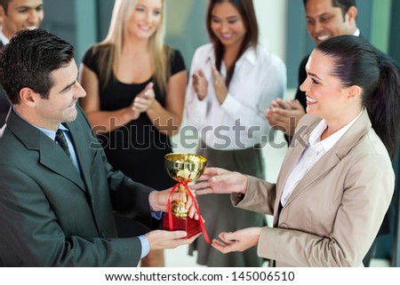 happy business team winning a trophy