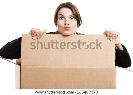 Happy business woman appear inside a big card box, isolated over white background