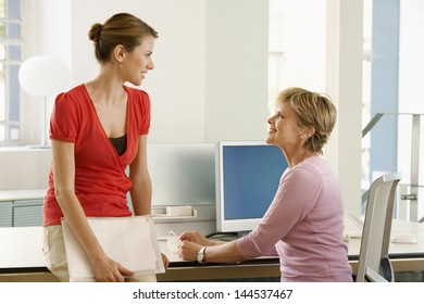 Happy Business Woman Discussing At Office Desk