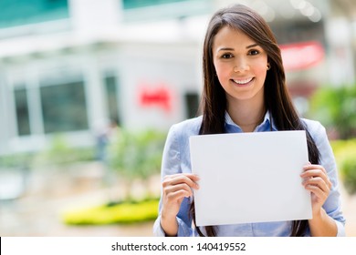 Happy business woman holding a banner and smiling