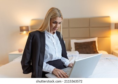 Happy business woman at hotel room working on a laptop on the bed and smiling lifestyle concepts, Business trip