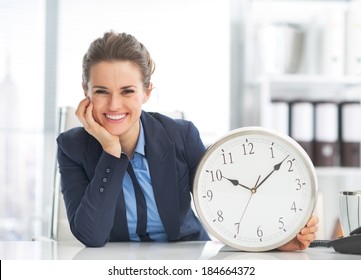 Happy Business Woman Showing Clock