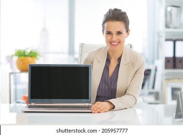 Happy Business Woman Showing Laptop Blank Screen