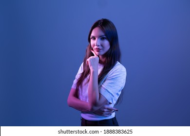 Happy Business Woman Standing On Neon Studio Background. Beautiful Female  Portrait. 