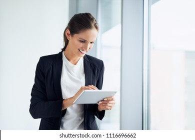 Happy Business Woman Using Tablet At Corporate Office