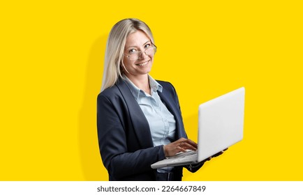 Happy business woman working with laptop - Shutterstock ID 2264667849