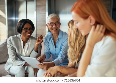 Happy business woman working together online on a tablet. - Shutterstock ID 713636704