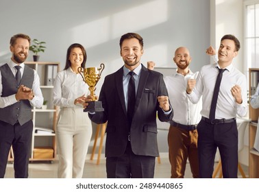 Happy businessman awarded prize for victory, business leader success, winning team celebrating in admiration. Office worker achieves wealth, respect or fame, acknowledged by friendly coworkers group - Powered by Shutterstock