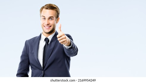 Happy businessman in black suit, white shirt, necktie show thumb finger up, like, agree hand gesture, isolated on grey background. Excited young business man at studio image. Success ad concept. - Shutterstock ID 2169954249