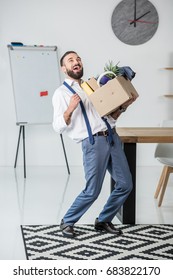 Happy Businessman With Cardboard Box In Hands Quitting Job