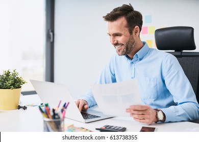 Happy Businessman Doing Data Entry Work At Office