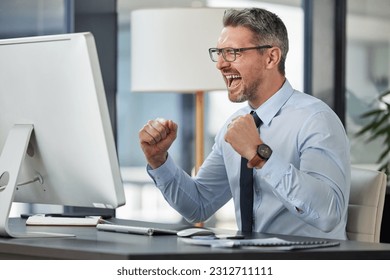 Happy, businessman and fist in celebration for promotion, winning or success by desk at the office. Man employee in joy for win, achievement or bonus on computer in sale, target or prize at workplace