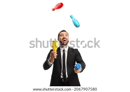 Happy businessman juggling with clubs isolated on white background