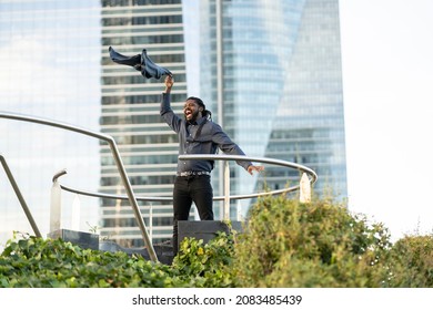 Happy Businessman Leaving Work Throwing His Jacket In The City