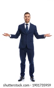 Happy Businessman In Navy Blue Suit Opening Arms And Smiling, Standing And Posing Isolated On White Background In Studio