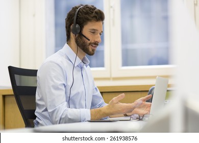 Happy Businessman In The Office On The Phone, Headset, Skype