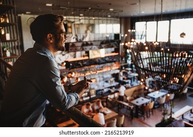 Happy businessman, restaurant owner proudly looking at crowded restaurant - Shutterstock ID 2165213919