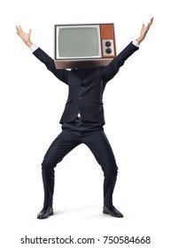 A happy businessman stands on a white background in a victory motion while wearing a retro TV box on his head. Defeat old ways. Business improvement. Successful strategy change.