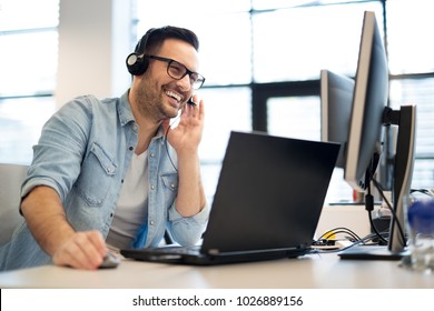 Happy businessman talking with headset