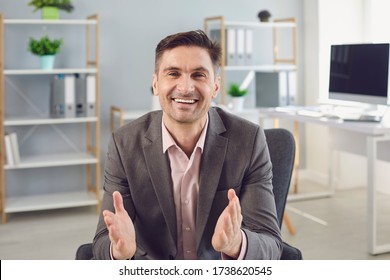 Happy Businessman Talking In Office Home. Man Looking At Camera Online.