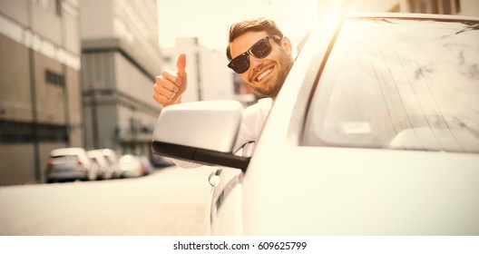 Happy businessman with thumbs up while driving car - Powered by Shutterstock