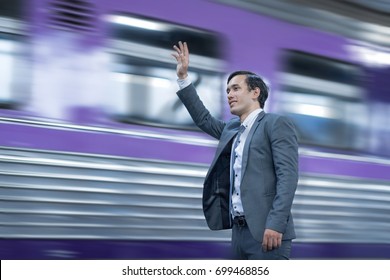 Happy Businessman Waving His Hand To Friend On Train.Send Colleagues Back Home.