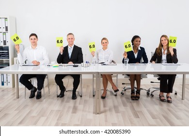 Happy Businesspeople Holding Voting Paper In Conference - Powered by Shutterstock