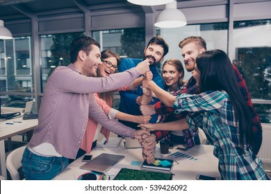 Happy businesspeople putting their fist on top of each other and laughing. They have training - Shutterstock ID 539426092